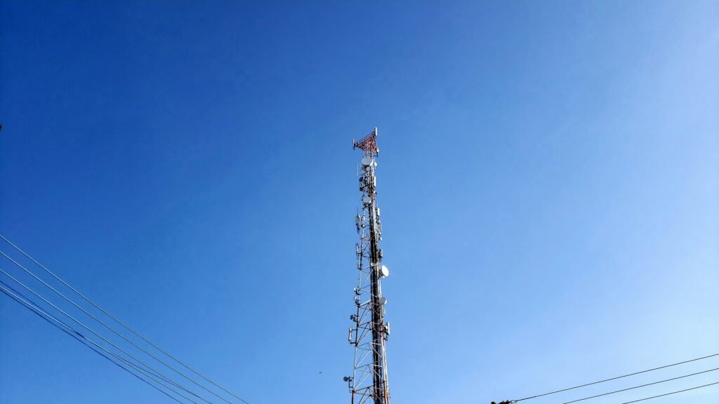 brown and white electric tower under blue sky during daytime